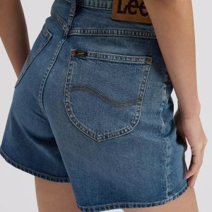 Back view of a person wearing blue denim shorts, showing the rear pocket and a brown Lee patch on the waistband.