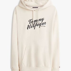 Cream hoodie with a large black 'Tommy Hilfiger' logo printed across the chest.