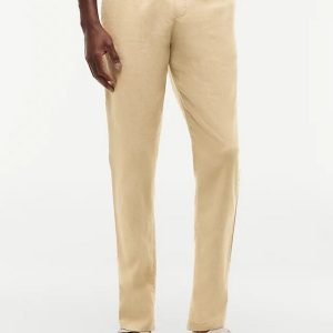 Beige drawstring linen pants worn by a person, paired with white sandals.