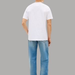 Back view of a man in a white T-shirt, blue jeans, and black shoes against a gray backdrop, casual outfit.