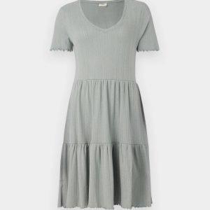 Sage-green knit dress with a V-neck, short sleeves, and a three-tiered gathered skirt