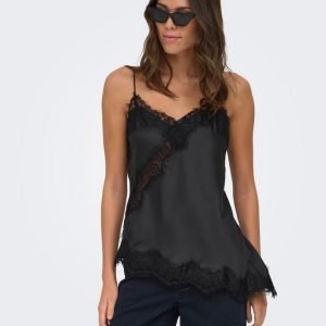Woman wearing a black satin lace-trim camisole with spaghetti straps and dark sunglasses, posing against a pale background.