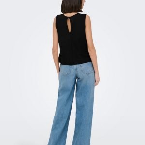 Back view of a woman wearing a sleeveless black top with a teardrop keyhole opening and wide-leg blue jeans.