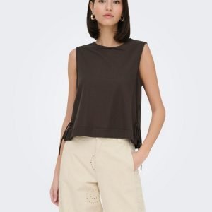 Model wearing a sleeveless dark brown top with side ties and light beige embroidered wide-leg pants, standing against a light background.