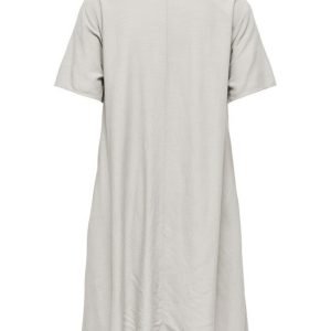 Back view of a loose beige knee-length shirt dress with short sleeves and a collar, hanging straight down from the shoulders.